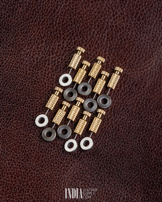 Several brass positioning needles with black and silver washers