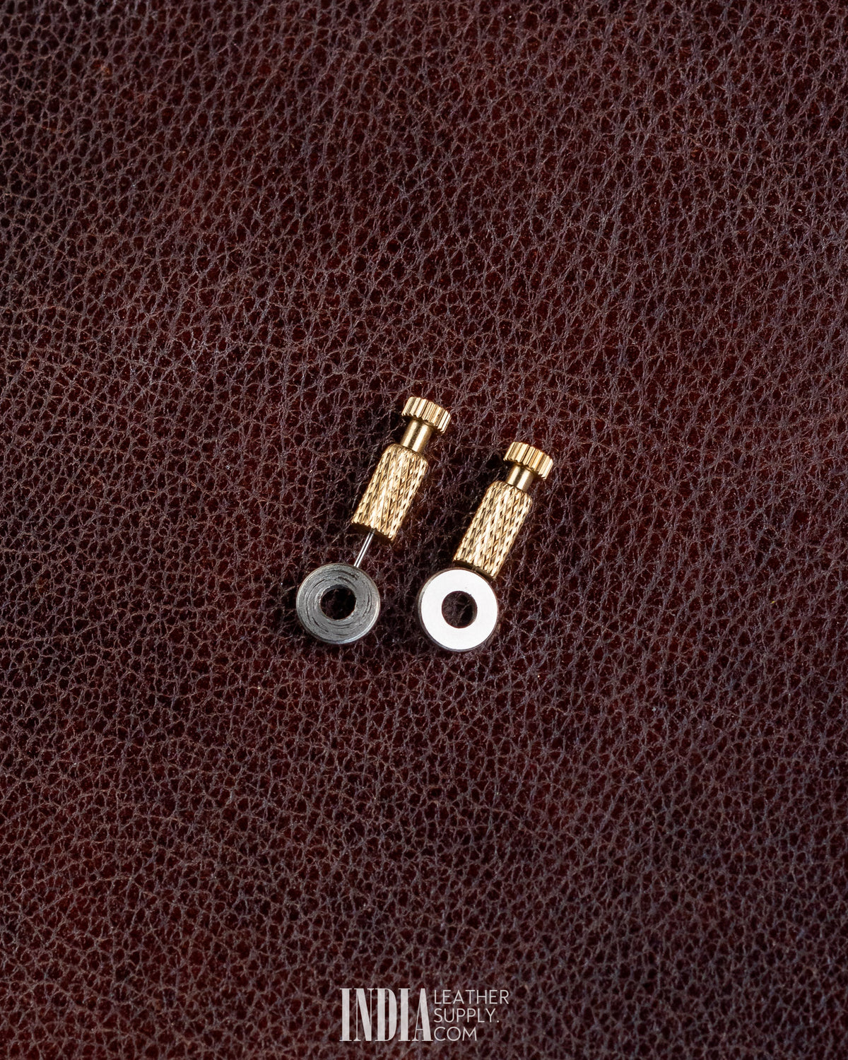 Two brass positioning needles with washers